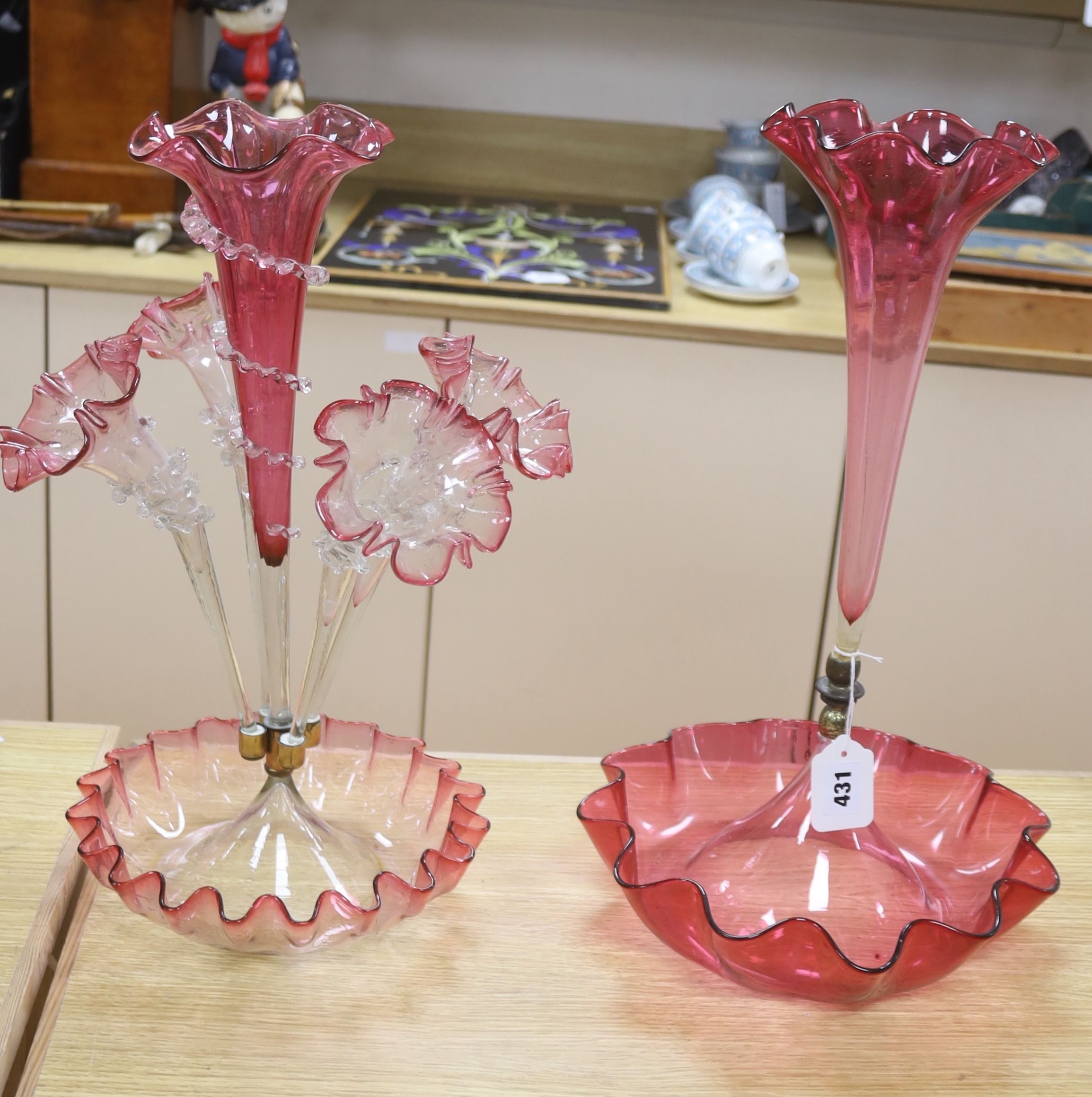 A Victorian cranberry glass four branch epergnes and a single glass epergne, tallest 47cm